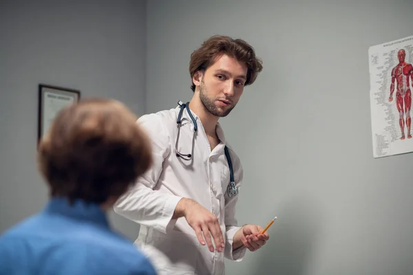 A family doctor conducting a medical checkup of his patient