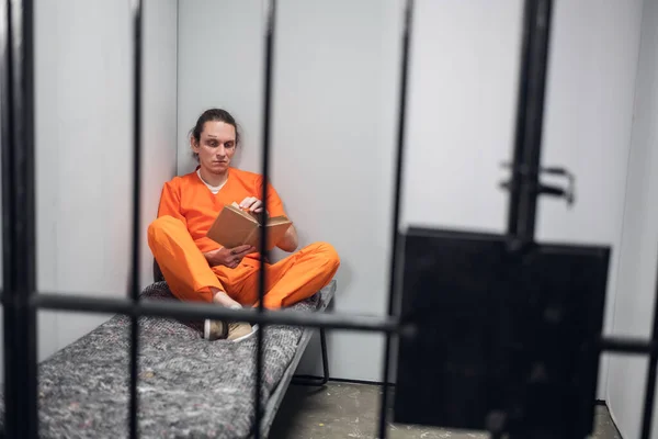 A sad depressed prisoner is serving a long time in prison in solitary confinement for crimes committed. — Stock Photo, Image