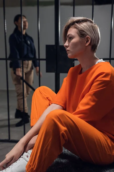 Sad criminal girl in her cell on a bed worries about her fate — Stock Photo, Image