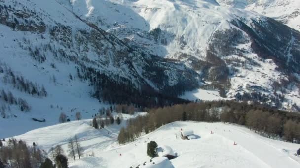 matterhorn mountain and skiers on piste in winter