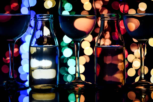 wine glasses and bottles in a row with colorful light painting behind, Set of wine glasses with red, white and rose wine, banner, alcohol drinks