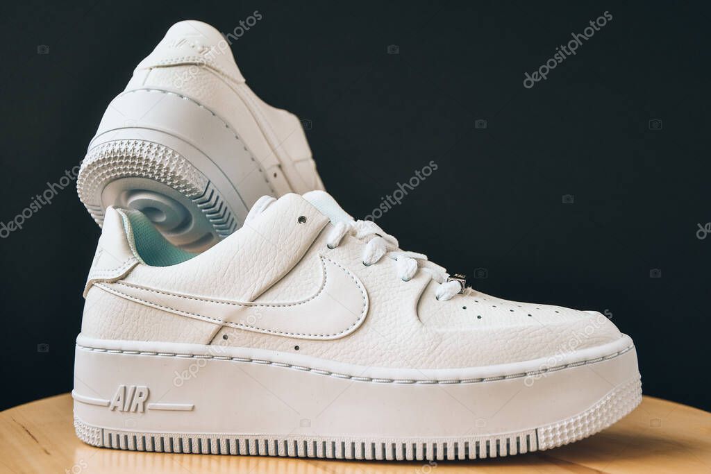Zhytomyr, Ukraine - June 1, 2020: Nike Air Force 1 Sage white sneakers product shot on black background. Illustrative editorial photo. Sport footwear