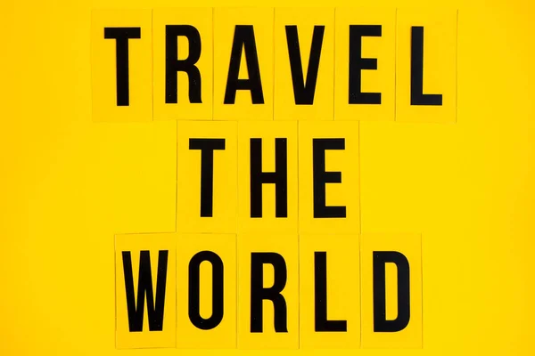Inscription Travel World Yellow Background Text Word Black Letters — Stock Photo, Image