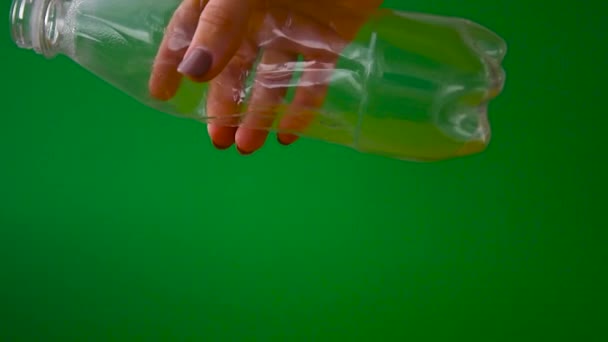 Hand squash a plastic empty bottle. Close up. Zero waste. Ecological recycling of disposable material. — Stock Video