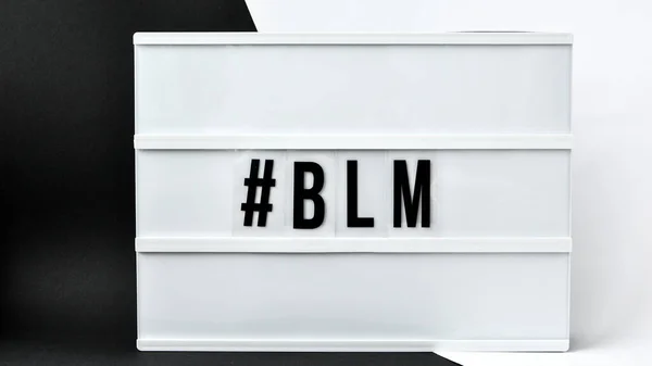 hashtag BLM BLACK LIVES MATTER text on a black and white background. Freedom of Speech Vintage Retro quote board. Protest against the end of racism, anti-racism, equality. Poster on violation of human rights