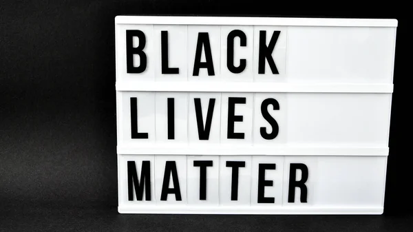 BLACK LIVES MATTER text on a black background. Freedom of Speech Vintage Retro quote board. Protest against the end of racism, anti-racism, equality. Poster on violation of human rights