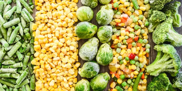 Different frozen vegetables as background, top view. Stocking up vegetables for winter storage. Assortment of frozen vegetables. Healthy food, Cooking ingredients