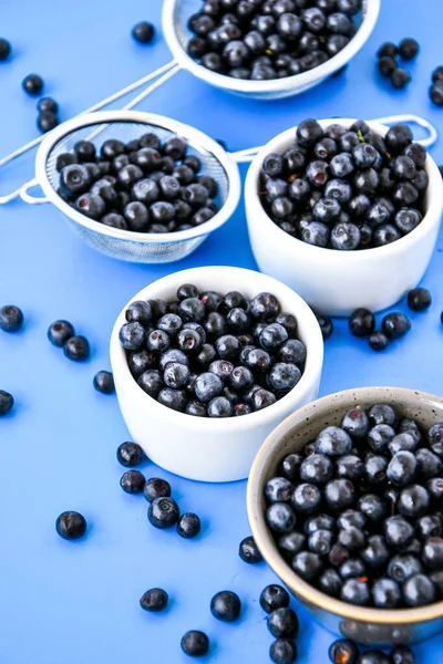 Berries. Blueberry. Forest Berries in a bowl on blue background. Background with selective focus. Copy space. Fresh recently picked blueberries