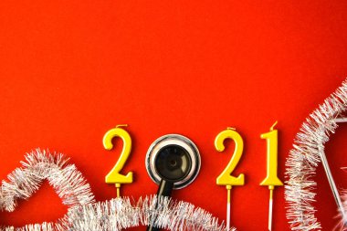 Tıbbi steteskoplu altın mumlardan yapılmış 2021 yılı. Uzayı kopyala Yeni yıl ve mutlu noeller tıbbi konsepti. Sağlıklı bir yaşam tarzı. Hastane dekorasyonları