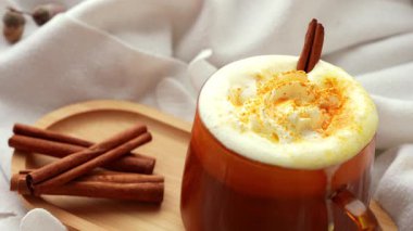 Sonbahar higge turuncu kahve fincanı masadaki sıcak kahve yaprakları yağmur damlalarına karşı penceredeki bardaktan aşağı akıyor. Samimi düşüşün canlı görüntüleri mum yakıyor. Şükran Günü ve Cadılar Bayramı