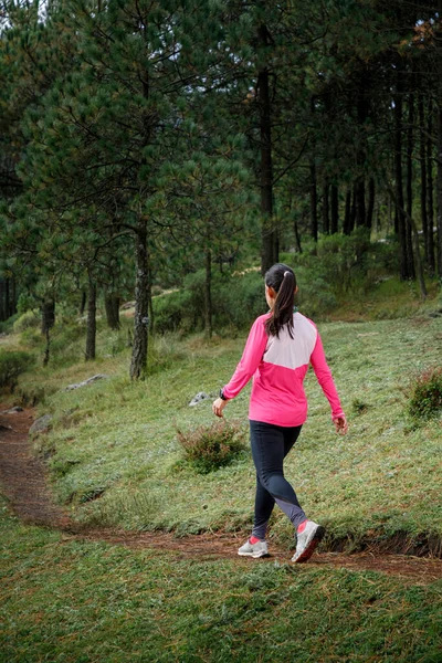 Athlete walking in the forest after running in the mountains
