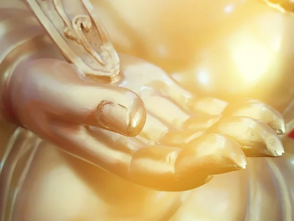 Golden hand of buddha statue close up