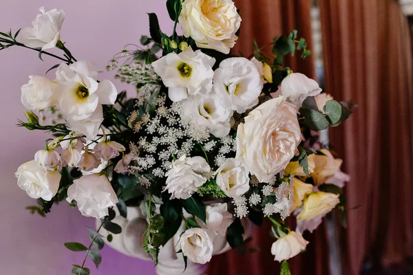 Beautiful flower arrangement of roses in a vase. Beautiful set up for the wedding ceremony. Rose, eustoma, tulip, eucalyptus