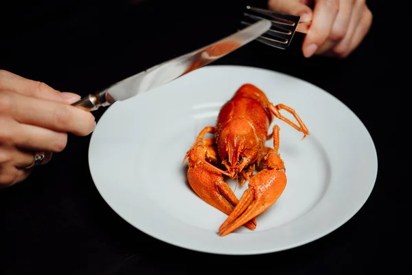 Boiled Crayfish White Plate Knife Fork Hand Black Background Minimalism — Stock Photo, Image