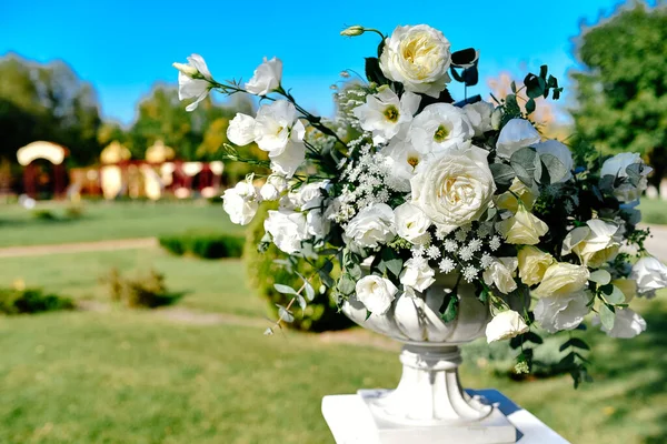 Beautiful flower arrangement of roses in a vase. Beautiful set up for the wedding ceremony. Rose, eustoma, tulip, eucalyptus