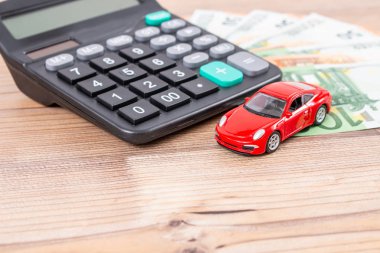 Sigorta, kredi ve araba konsepti. Kırmızı araba ve euro banknotları. Hesap makinesi, avro parası ve kırmızı araba. Uzayı metin için kopyala. Arabanın maliyetini hesapla.