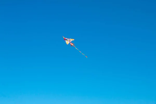 Kite fly in a blue sky. Copy space for text.