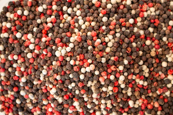 Texture of spices mix close-up, spice or seasoning as background. Black Pepper, Red pepper and White pepper mix.