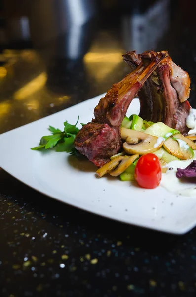 Tasty grilled ribs with vegetables on the white table — Stock Photo, Image