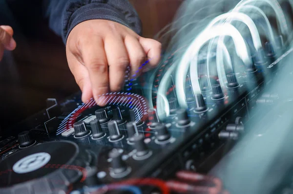 DJ mixing music on console at the night club