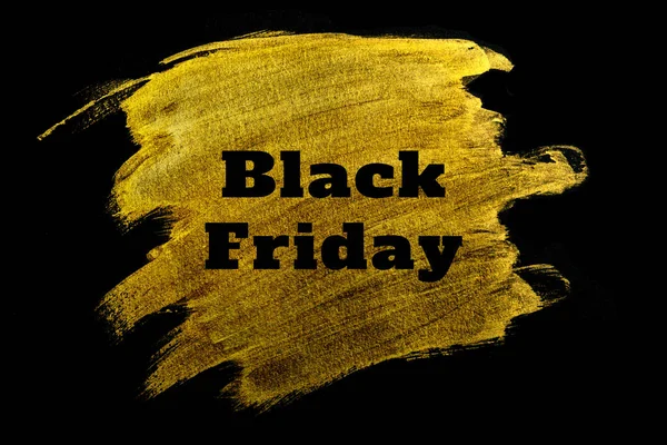 Black friday. Black lettering on gold acrylic paint strokes.