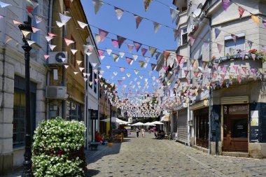 Plovdiv, Bulgaristan - 08 Haziran 2018: Kimliği belirsiz kişi ve şehir merkezindeki trafiğe kapalı alanda restoranlarda, Arnavut kaldırımlı sokakta süslenmiş şehir oldu Avrupa kültür başkenti 2019, küçük bayraklar