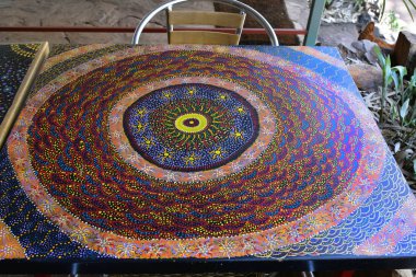 Alice Springs, NT, Australia - November 20, 2017: Table painted from unknow artist in traditional Aborigene painting technique clipart