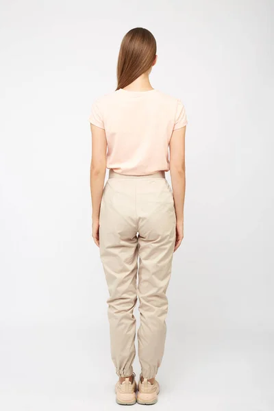 Flicka i beige last byxor och en t-shirt — Stockfoto