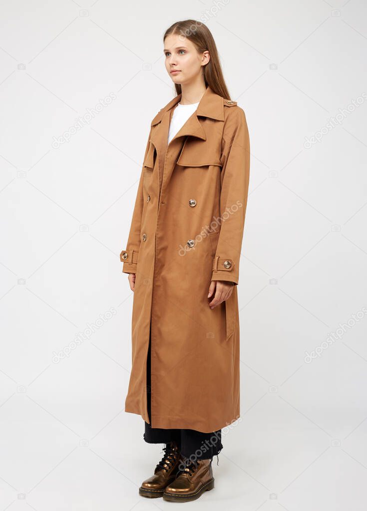 Female trench coat camel color isolated on white background.