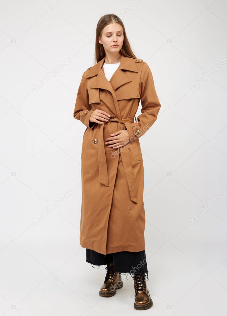 Female trench coat camel color isolated on white background.