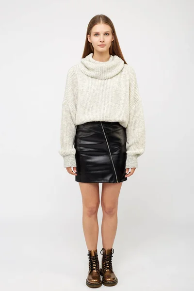 A girl dressed in a white sweater and a black eco-leather skirt — Stock Photo, Image