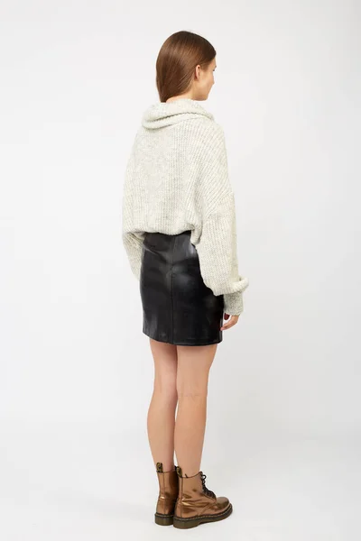 A girl dressed in a white sweater and a black eco-leather skirt — Stock Photo, Image