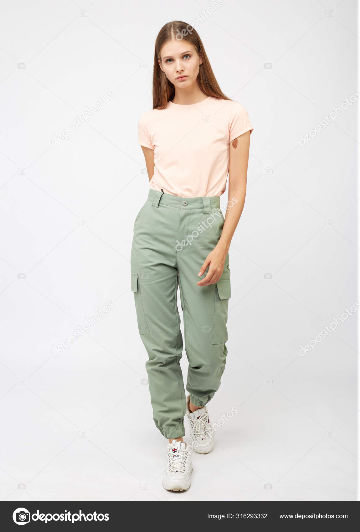 Girl in green cargo pants and a t-shirt Stock Photo by ©foxalexey