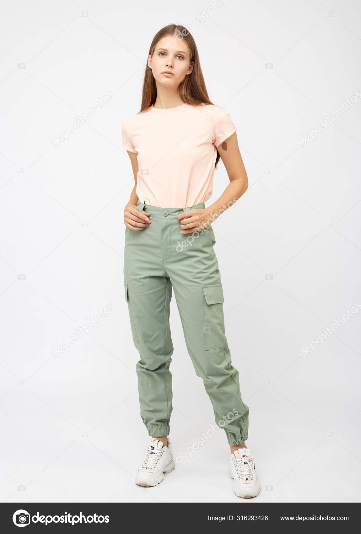 Girl in green cargo pants and a t-shirt Stock Photo by ©foxalexey 316293426