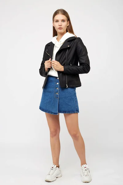 Girl in a denim skirt and a black jacket — Stock Photo, Image