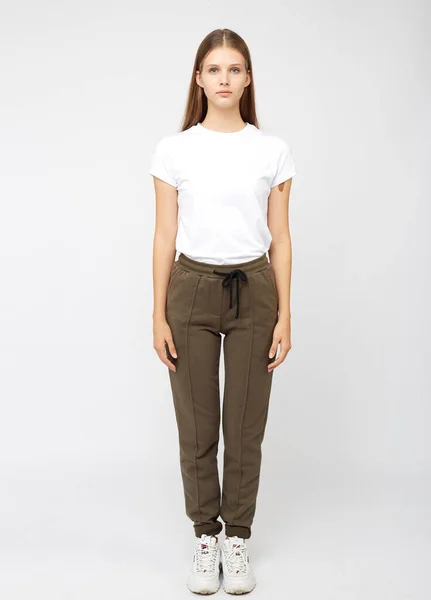 Girl in khaki sweatpants and a t-shirt — Stock Photo, Image