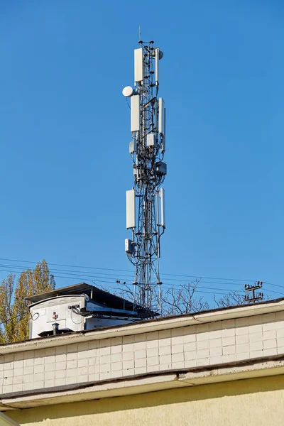 Technology on the top of the telecommunication GSM 5G,4G,3G tower.Cellular phone antennas on a building roof.Telecommunication mast television antennas.Receiving and transmitting stations