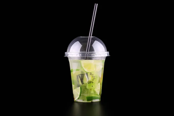 Lemonade to go cup with mint, lime and kiwi on black background, isolated