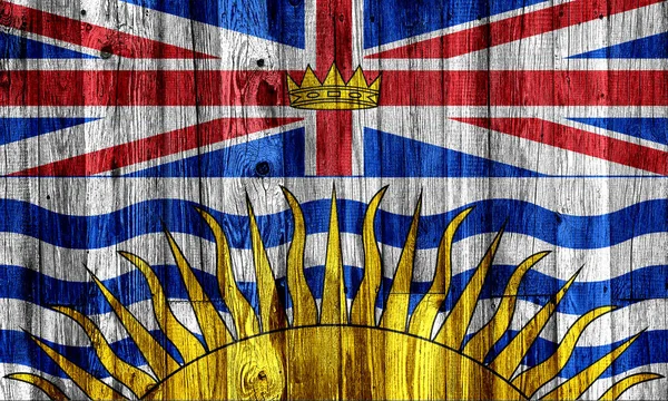 不列颠哥伦比亚省国旗涂在木制背景上，特写. — 图库照片