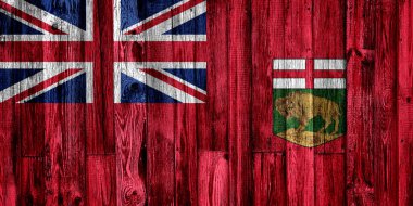 Ahşap arka planda Manitoba bayrağı, yakın plan.