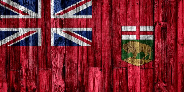 马尼托巴省国旗涂在木制背景上，特写. — 图库照片