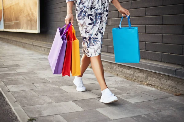 Black friday. Woman holding paper bags in her hand. Shopping mall.