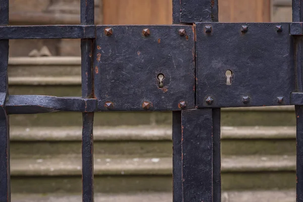 Old wrought iron gate with double lock