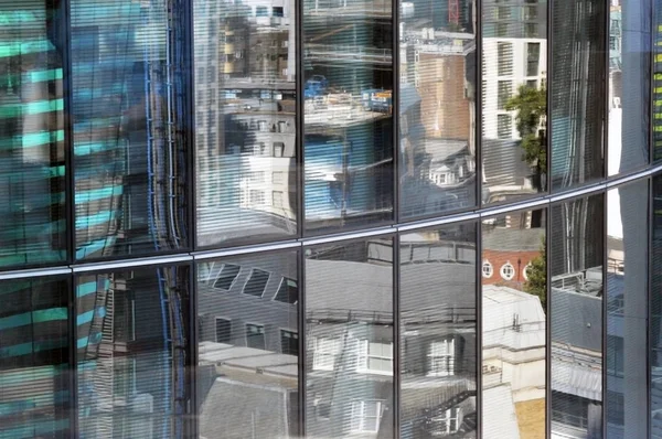 Blurry reflections of buildings on modern glass facade