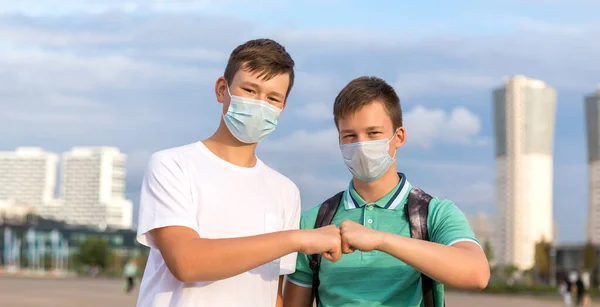 Two friends of teenagers meet in the city. They greet each other without contact . — Stock Photo, Image