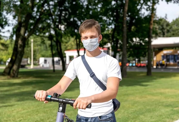 Tonåring Åker Skoter Parken Hans Ansikte Medicinsk Mask Vertikalt Foto — Stockfoto