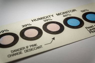 Elektronik imalat endüstrisinden gelen nem göstergelerinin yakın plan görüntüleri. Mavi noktalı, pembe renkli nemi gösteriyor.