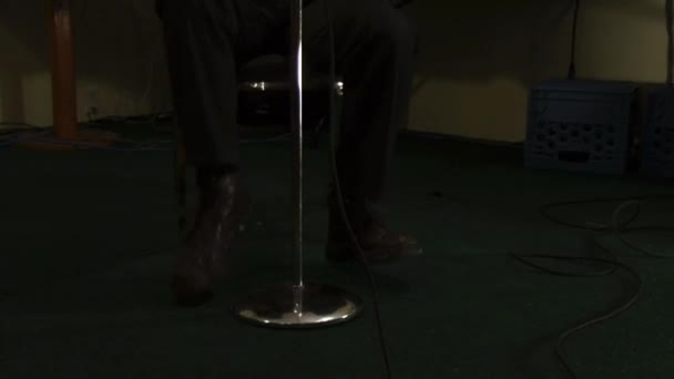 Man Big Shoes Tapping Microphone His Legs — Stock Video