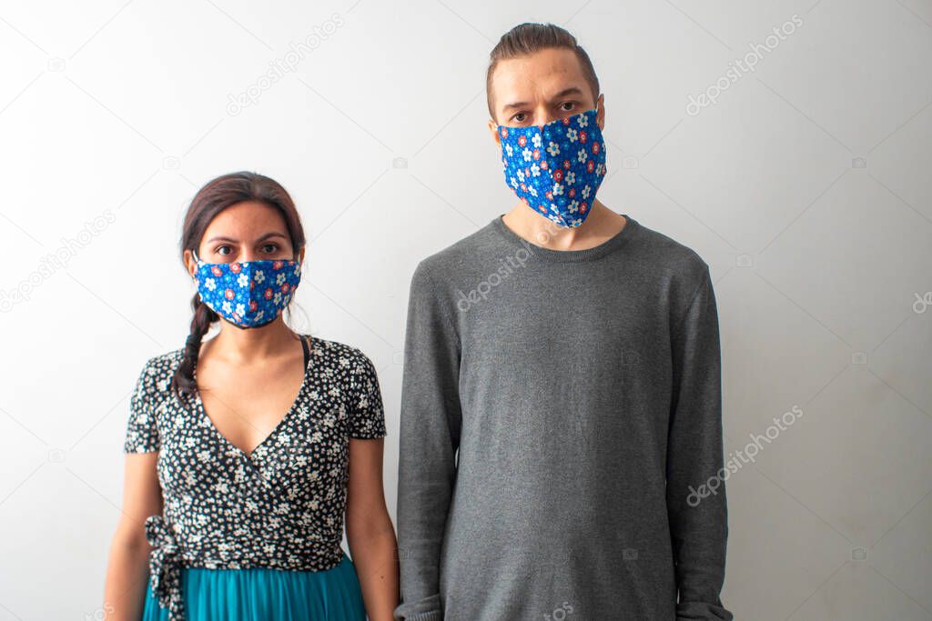 Young Blond Hair Caucasian Male and Brown Hair Hispanic/Latin Woman are Wearing Face Mask for Covid-19 Pandemic