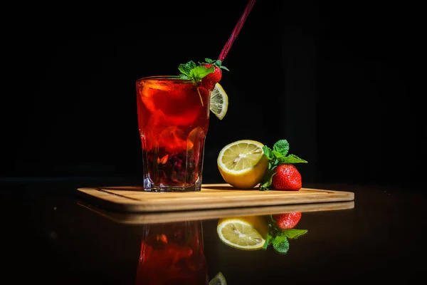 Fresh cocktail on a black background. Alcoholic cocktail on a black background. Fruit with a cocktail. Non-alcoholic cocktail. Mix of cocktails on a black background.